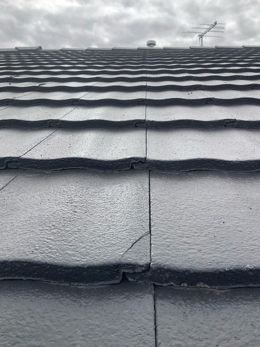 Cracked roof tile that needs replacing before it lets water into the roof, found during a fixing inspection in Aintree