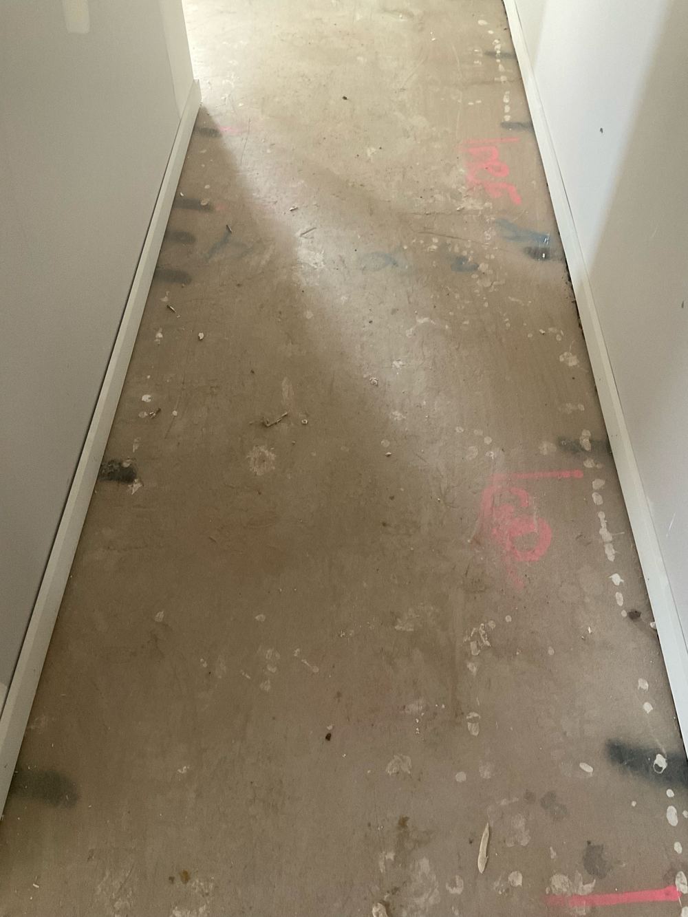 Slab surface needing patching and scraping before floor coverings go down, found during a fixing inspection in Aintree
