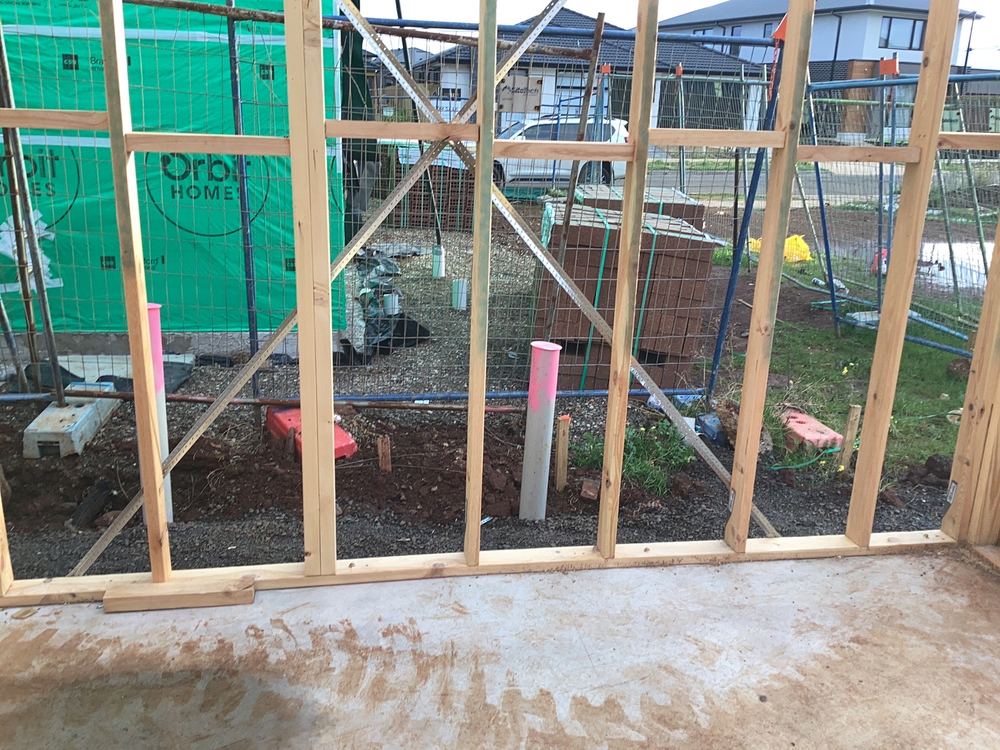 Metal bracing straps fixed with fewer nails than the standard requires, found during a frame inspection in Aintree