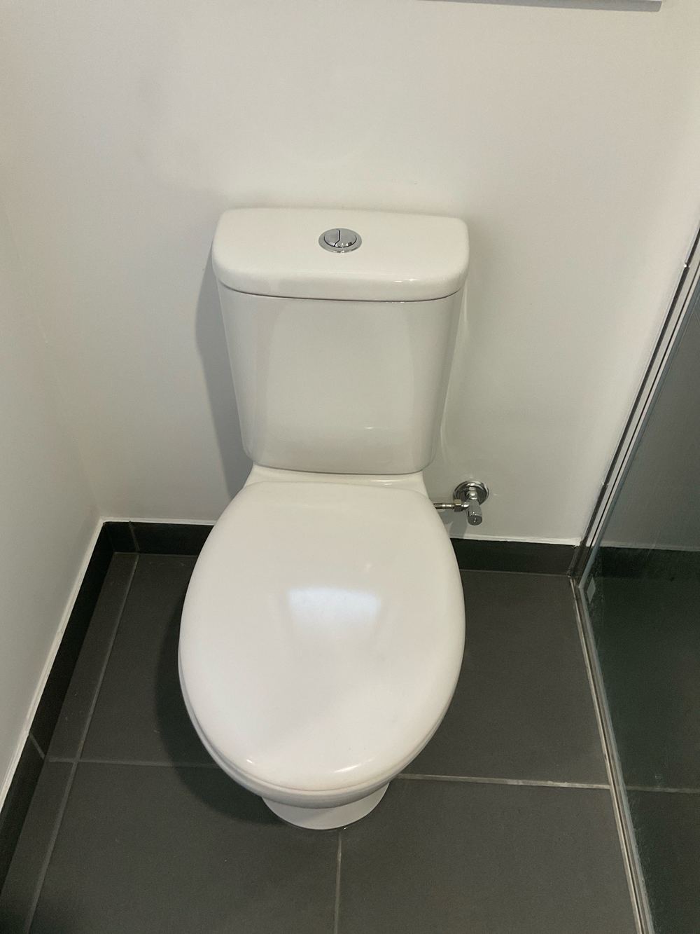 Toilet cistern loose and rocking on the pan, found during a pre-handover inspection in Aintree