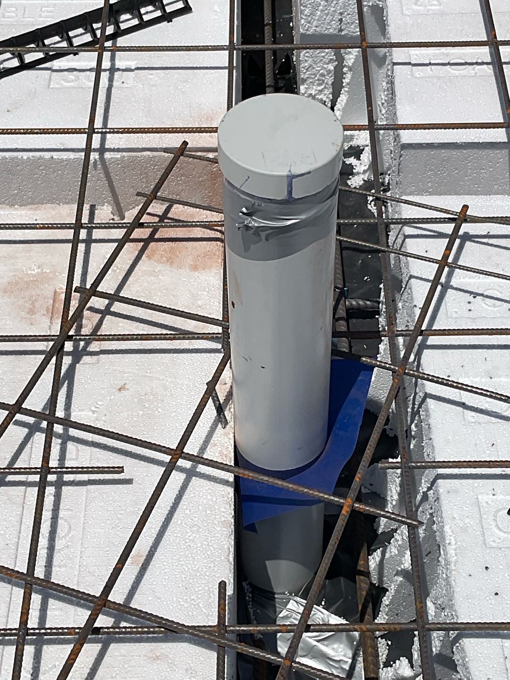 Reinforcement short of its required concrete cover, which exposes it to corrosion over time, found during a slab pre-pour inspection in Aintree