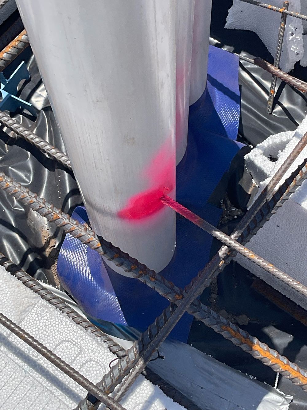 Slab mesh touching a service pipe where a 25mm gap is required, found during a slab pre-pour inspection in Aintree